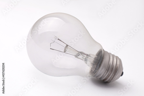 Vintage filament lamp light bulb laying on white table