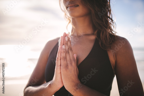 Woman practicing yoga meditation on the beach