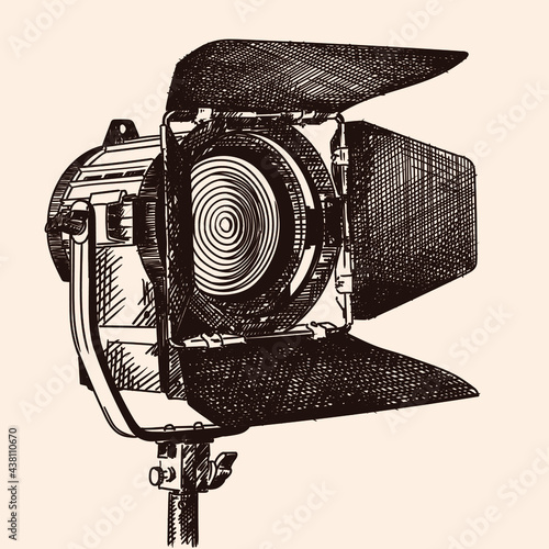 Constant light illuminator with curtains and fresnel lens on a stand for filming movies. The device is isolated on a beige background.