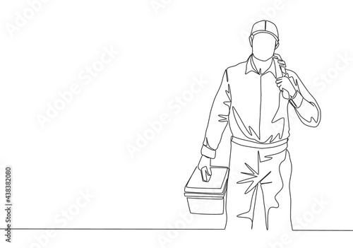 One continuous line drawing of young attractive plumber carrying tools box and ready to do home kitchen pipe service. House maintenance service concept single line draw design illustration