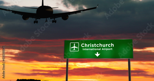 Plane landing in Christchurch New Zealand airport with signboard