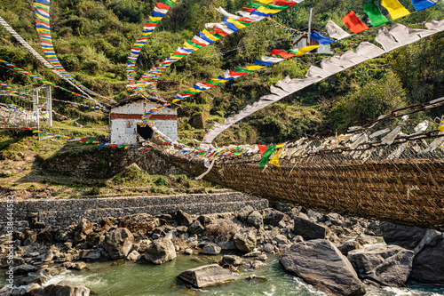 ancient holy bamboo bridge with many buddhist holy flags from flat angle