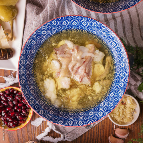 Caucasian soup khash with puri flat bread and greens Khash - dish of boiled cow's feet. traditional dish in Afghanistan, Azerbaijan, Bosnia and Hercegovina, Bulgaria, Georgia, Iran, Iraq