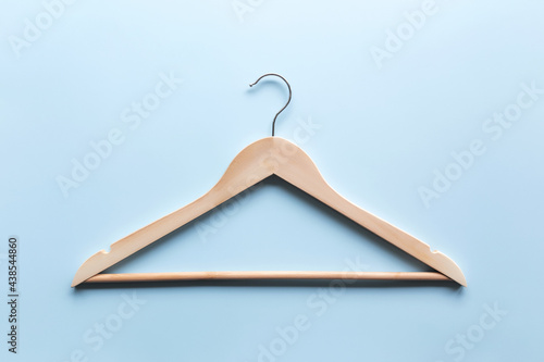 Black Friday or clothing industry concept on blue background with wooden hanger