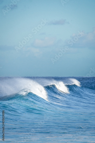 Three waves braking on the sea in Reunion Island