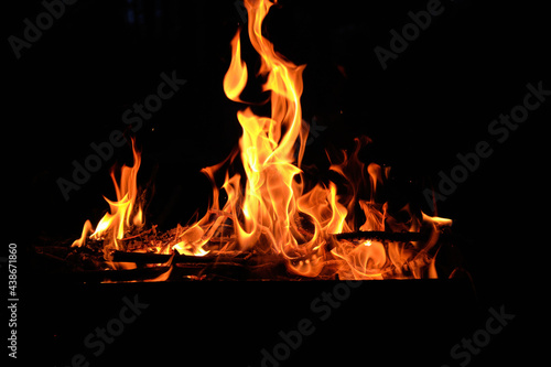 flames at night. Fire flames on black background. tongues of flame on the background of coals