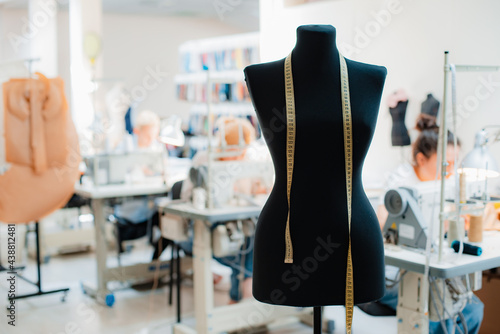 studio mannequin dummystylish fashionable trendy clothes on hangers, dressmaking workplace, tailor shop, sewing workshop
