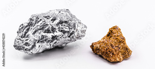 bauxite ore and aluminum stone together on isolated white background, industrial use ore.