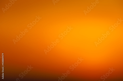 Blurred sunset sky. Abstract orange gradient color as a background