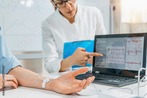 Biofeedback - Female hand with attached sensors for heart rate measurement.