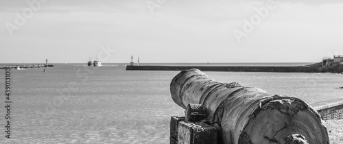 Vendée, FRANCE; May 27, 2021: Black and white photo of the cannon of the entrance to the port of Saint Gilles Croix de Vie, English cannon from 1747 sunk on the island of Noirmoutier. 