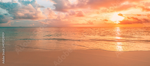 Closeup sea sand beach. Panoramic beach landscape. Inspire tropical beach seascape horizon. Orange and golden sunset sky calmness tranquil relaxing sunlight summer mood. Vacation travel holiday banner