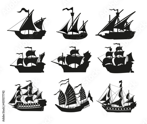Pirate boats and Old different Wooden Ships with Fluttering Flags. Vector Set Old shipping sails traditional vessel pirate symbols garish vector illustrations.Black silhouettes collection set