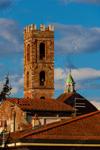 View of the Church of Saints John and Reparata medieval bell tower and dome among clouds rises above Lucca charming historic center roofs
