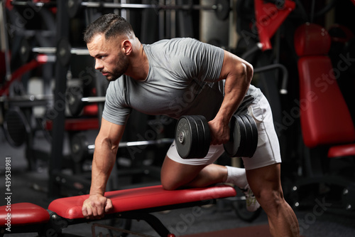 Man doing dumbbell row workout