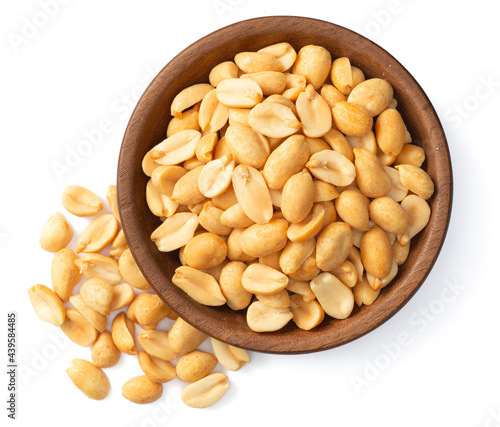 cooked peanuts in the wooden plate, isolated on white background, top view