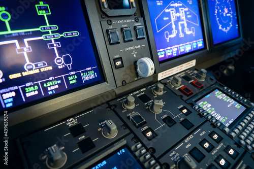 A typical dashboard panel in the cockpit of a private jet plane aircraft. Gear lever in focus.