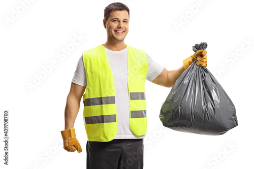 Man in a vest holding a black plastic bin bag