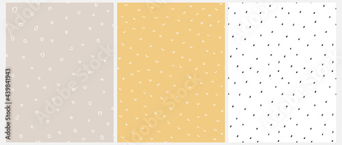 Abstract Geometric Seamless Vector Pattern with White and Black Irregular Brush Spots Isolated on a Dusty Beige, Pale Yellow and White Background. Cute Simple Hand Drawn Repeatable Print. 