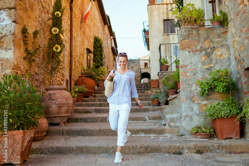 happy traveller woman in Tuscany, Italy exploring attractions