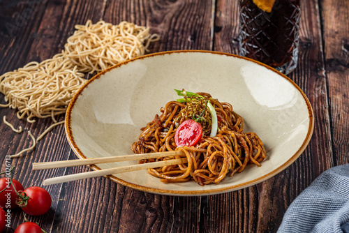 tomato and pepper noodles on wooden background