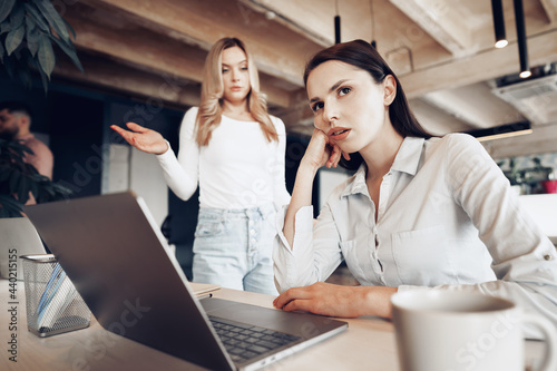 Young female boss scolding her female subordinate for bad work results