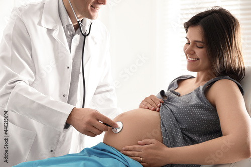 Doctor examining woman before giving child birth in maternity hospital, closeup