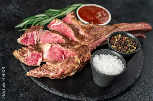 Grilled tomahawk steak on stone background
