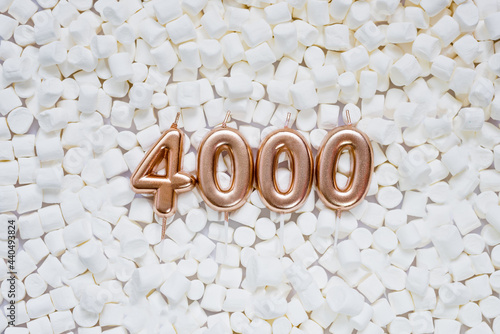 4000 followers card. Template for social networks, blogs. Background with white marshmallows. Social media celebration banner. 4k online community fans. Four thousand subscriber