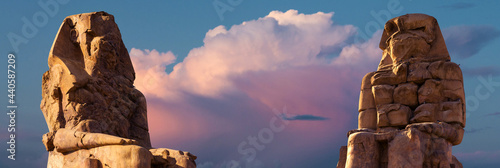 Colossi of Memnon Luxor Thebes against the background of dawn in the Egypt