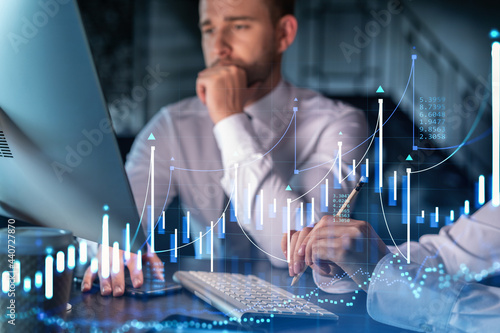 Two colleagues in formal wear working together to optimize trading strategy at corporate finance fund. Forex chart hologram over modern office background