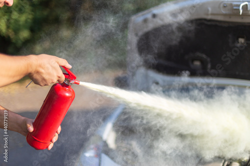 A man that use a fire extinguisher