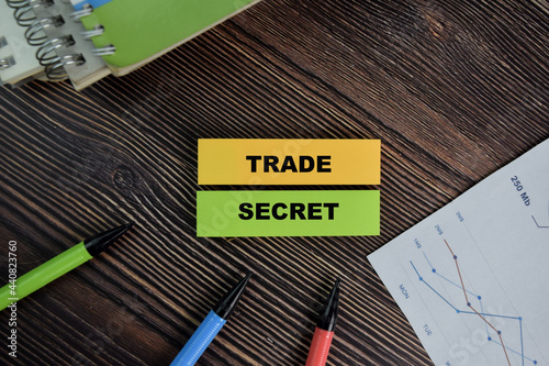 Trade Secret write on sticky notes isolated on Wooden Table.