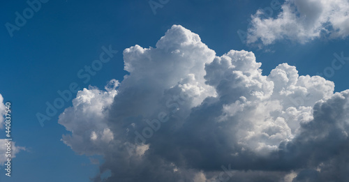  Beautiful cumulus clouds against the blue sky.. Panoramic shot of a cloud cluster. Wide format.