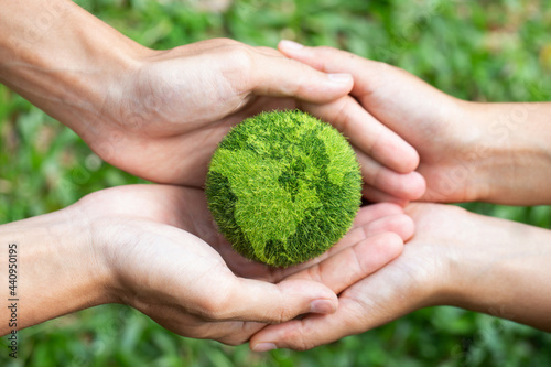 environment Earth Day two hands holding together a green earth. Environmental and reduce global warming help earth, top view. ecology and environment sustainable concept.