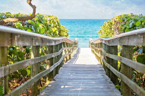 Wooden pier leading out to beautiful beach.