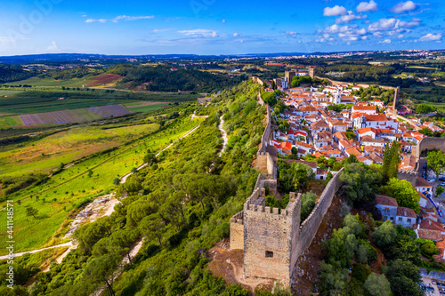 Aerial view of the historic walled town of Obidos at sunset, near Lisbon, Portugal. Aerial shot of Obidos Medieval Town, Portugal. Aerial view of medieval fortress in Obidos. Portugal.