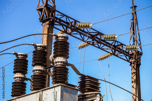 Power transmission tower with electric garland of insulators on transformer station