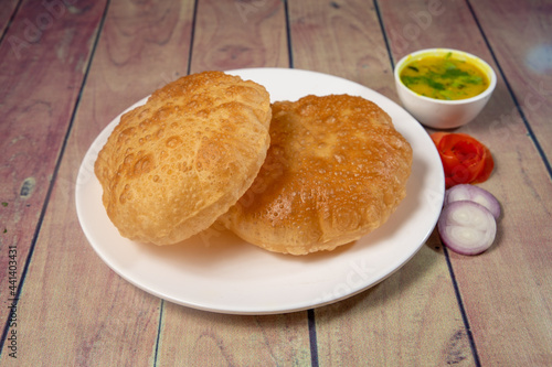 Close up of fried puri or poori on ceramic white plate