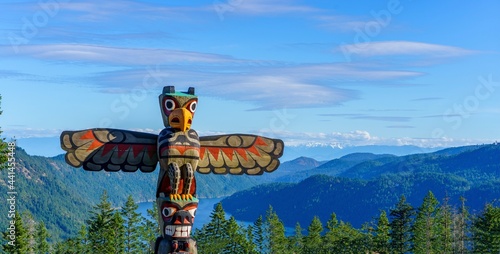 Totem pole towers over scenic wilderness and ocean