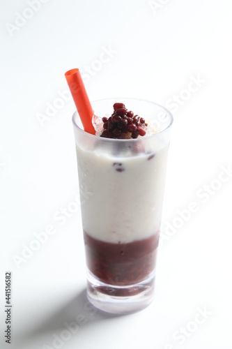 ice cold chilled fresh sweet coconut milk soya drink with red bean paste and red straw beverage menu in white background