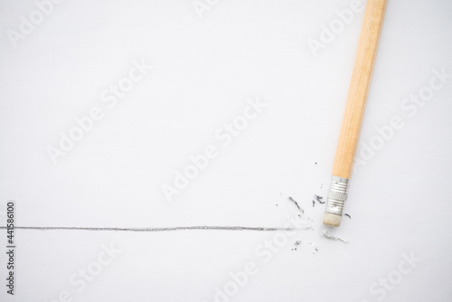 Flat lay of pencil eraser delete black line pencil on white paper background copy space. Repair, remove, creative idea, imagination and education concept.