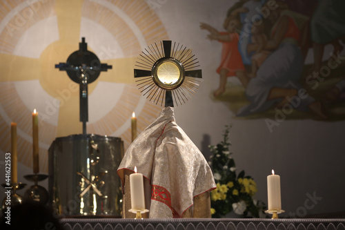 A priest holding a monstrance in the Church 