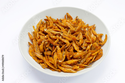 Fried Anchovies in white plate on white background.