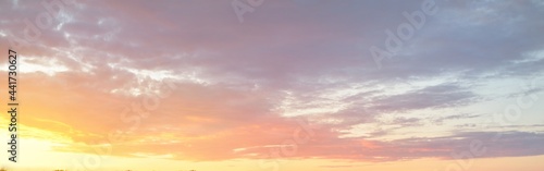 Clear blue sky. glowing pink, golden cirrus and cumulus clouds after storm, soft sunlight. Sunset cloudscape. Meteorology, midnight sun, heaven, peace, graphic resources, picturesque panoramic scenery