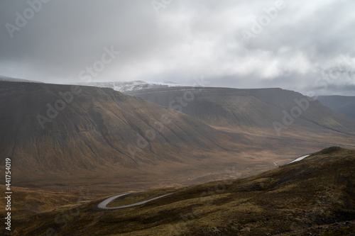 Winding curve road at West Fjords or The Westfjords region in north Iceland. Dramatic moody sky nature landscape