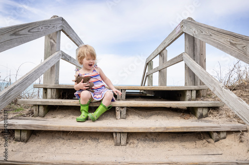 Toddler at Indiana Dunes National Park sitting on a boardwalk