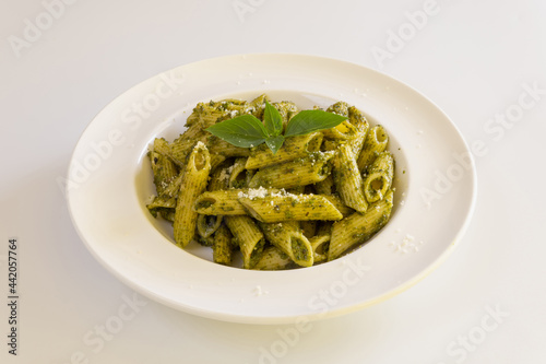 Homemade pesto sauce pasta on white background