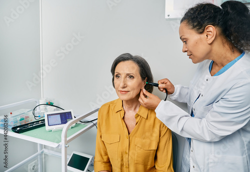 Tympanometry. Ent doctor doing tympanometry and test of middle-ear function to mature woman patient at hearing clinic