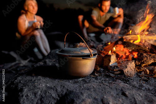 Close up shot of a cauldron. Cooking dinner in field conditions, boiling pot at the campfire